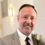 A photo of william howell in a suit