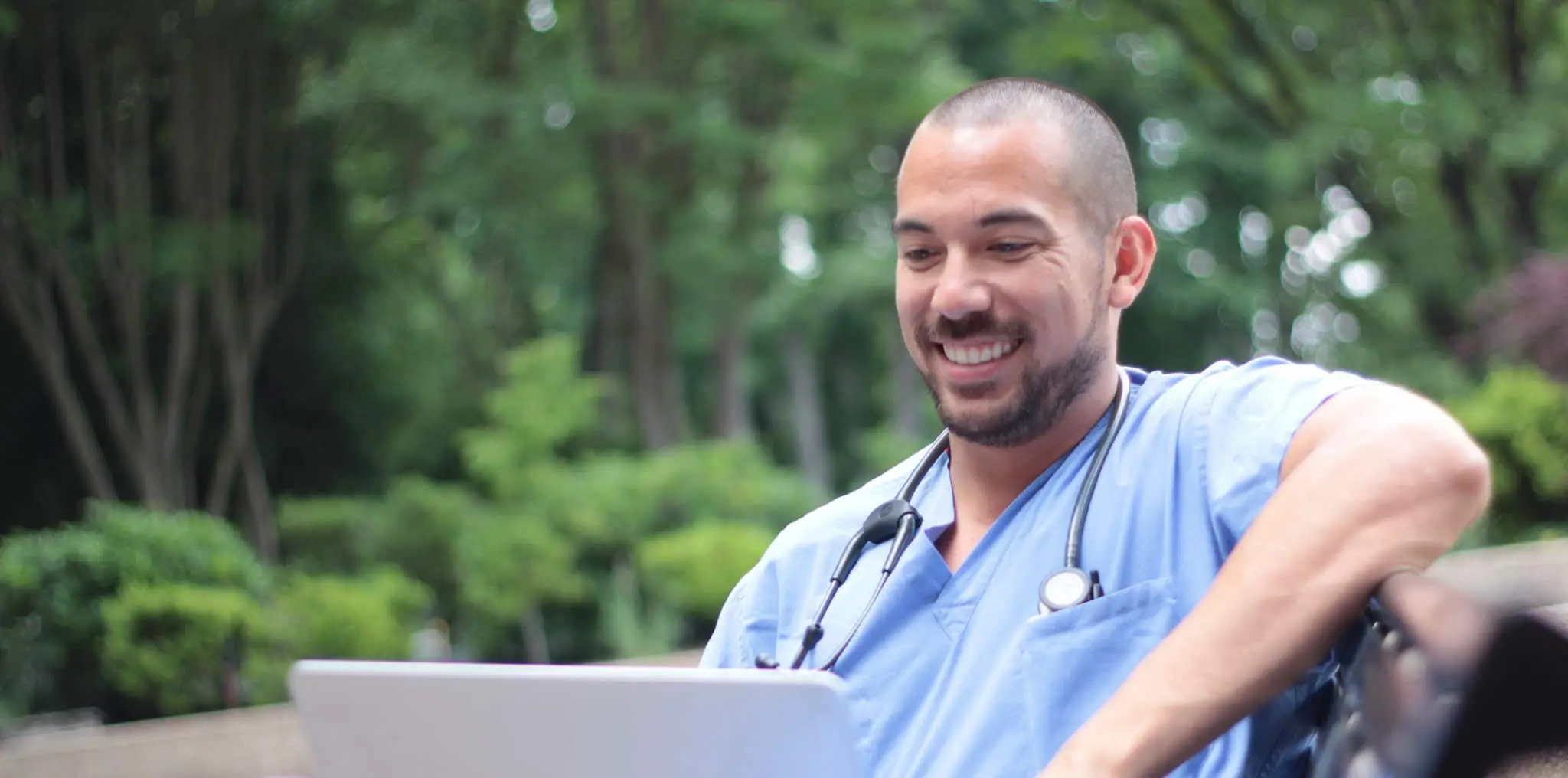 CRNA student sitting and studying on a laptop
